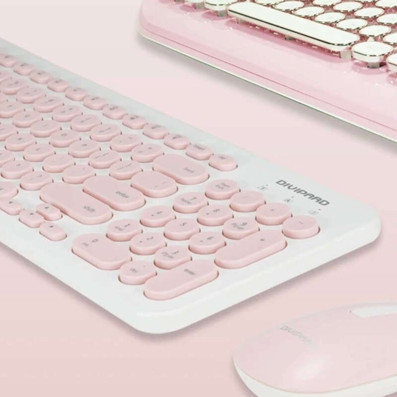 Pink keyboard with a matching mouse on a pink background