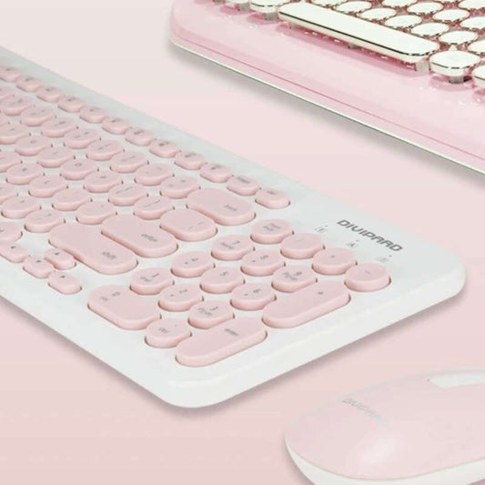 Pink keyboard with a matching mouse on a pink background