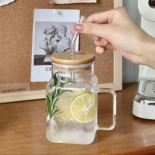 Glass jar with wooden lid and lemon slices on a wooden surface