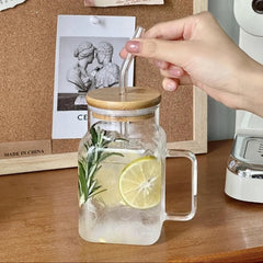 Glass jar with wooden lid and lemon slices on a wooden surface