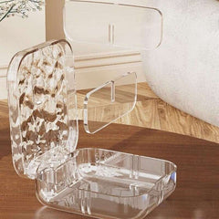 Clear acrylic phone stand on a wooden surface with a blurred background